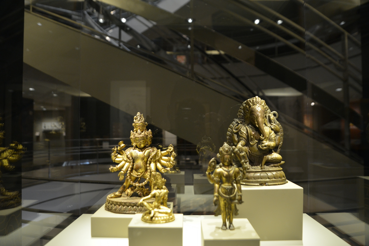 Gold Buddhist statues on display in a museum