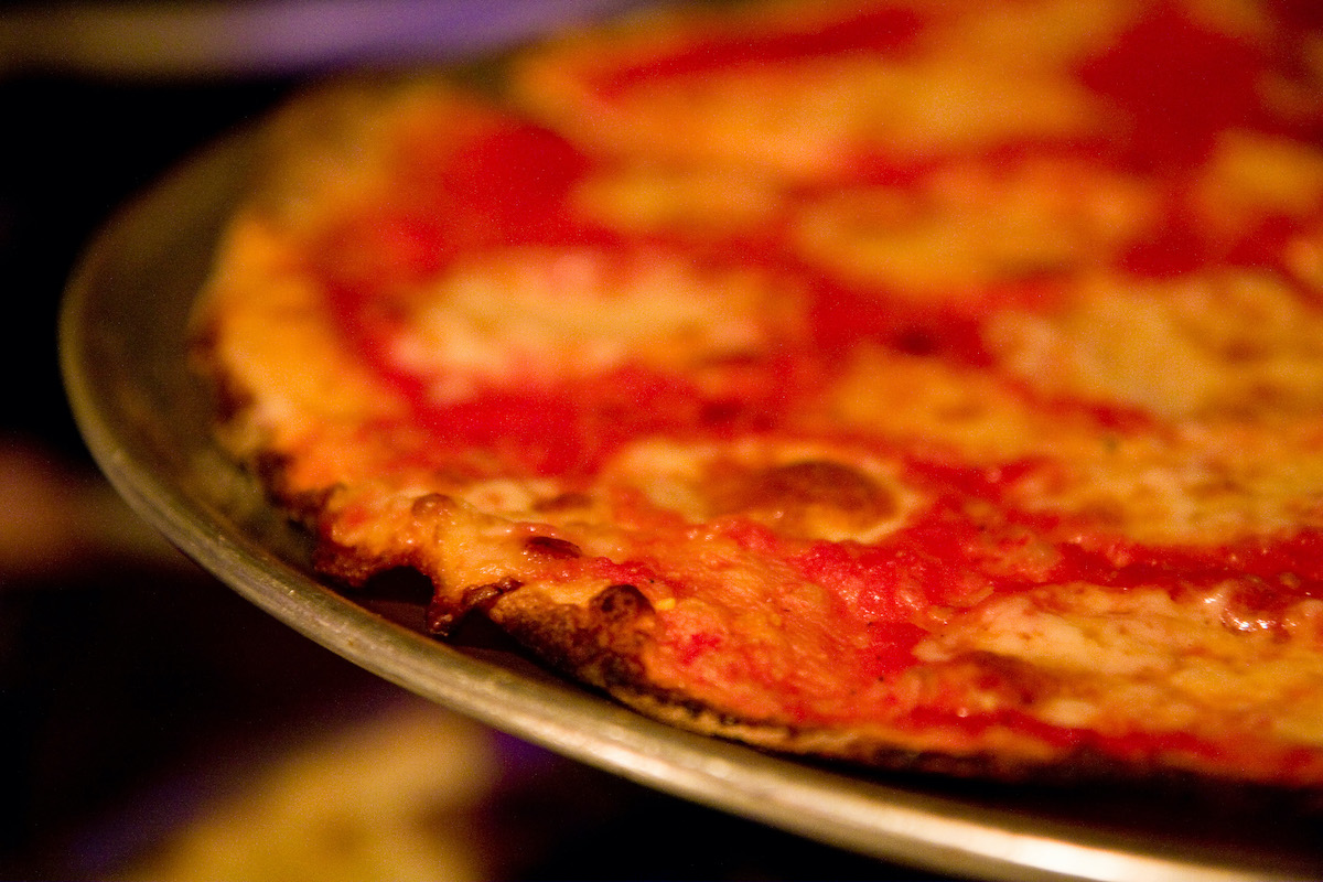Close up of a thin crust cheese pizza.