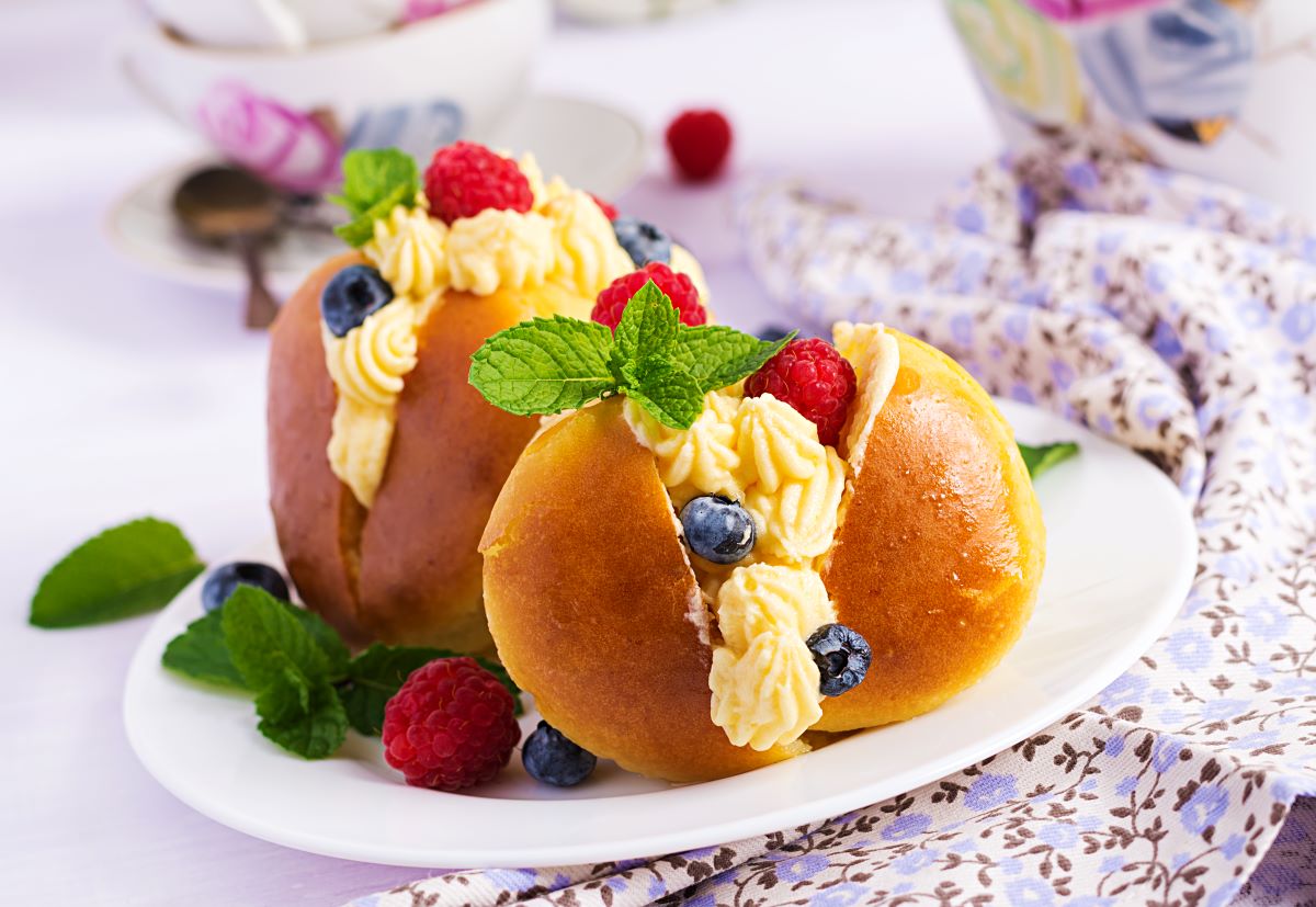 baba decorated with whipped cream fresh berries