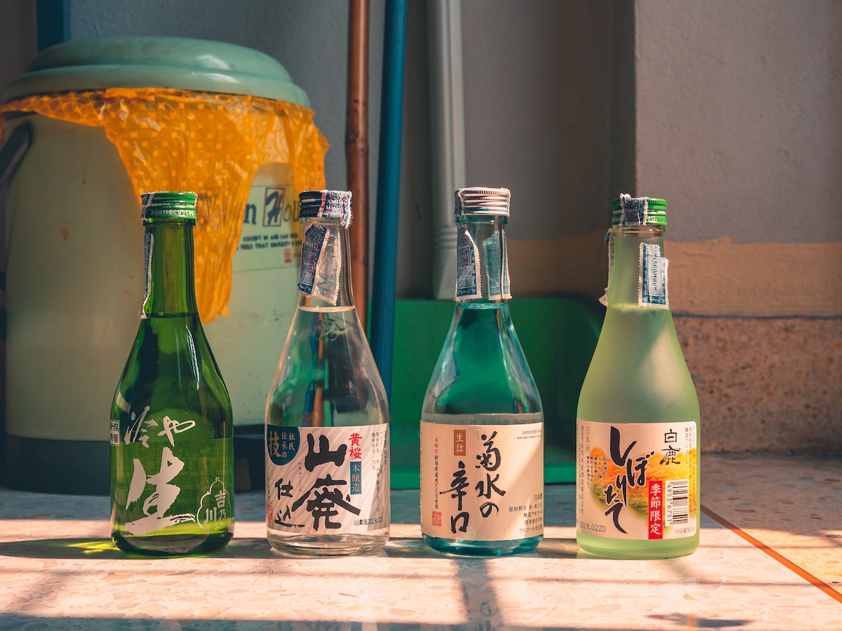 Four bottles of sake with Japanese writing on the labels