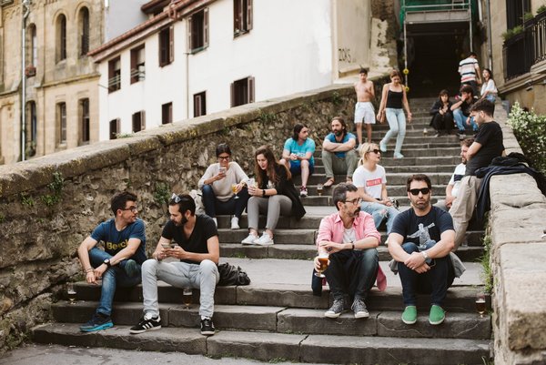 People sitting on some steps in San Sebastian