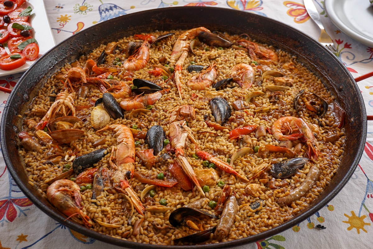 Seafood paella from above with shrimp, clams, mussels, and peas