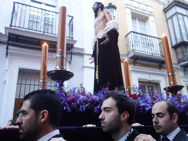Men carrying a Holy Week float in Seville, Spain