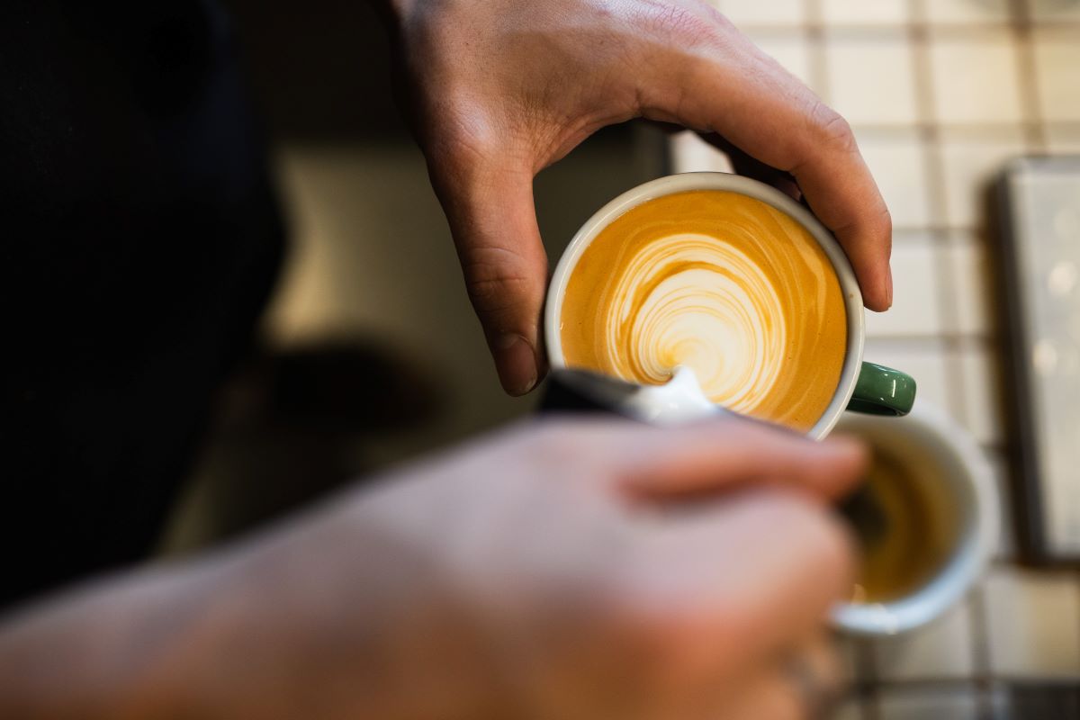 milk being poured into coffee