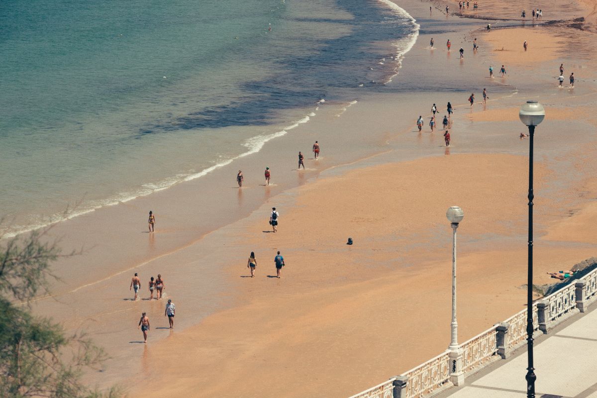 An aerial view of people walking on the beach in San Sebastian