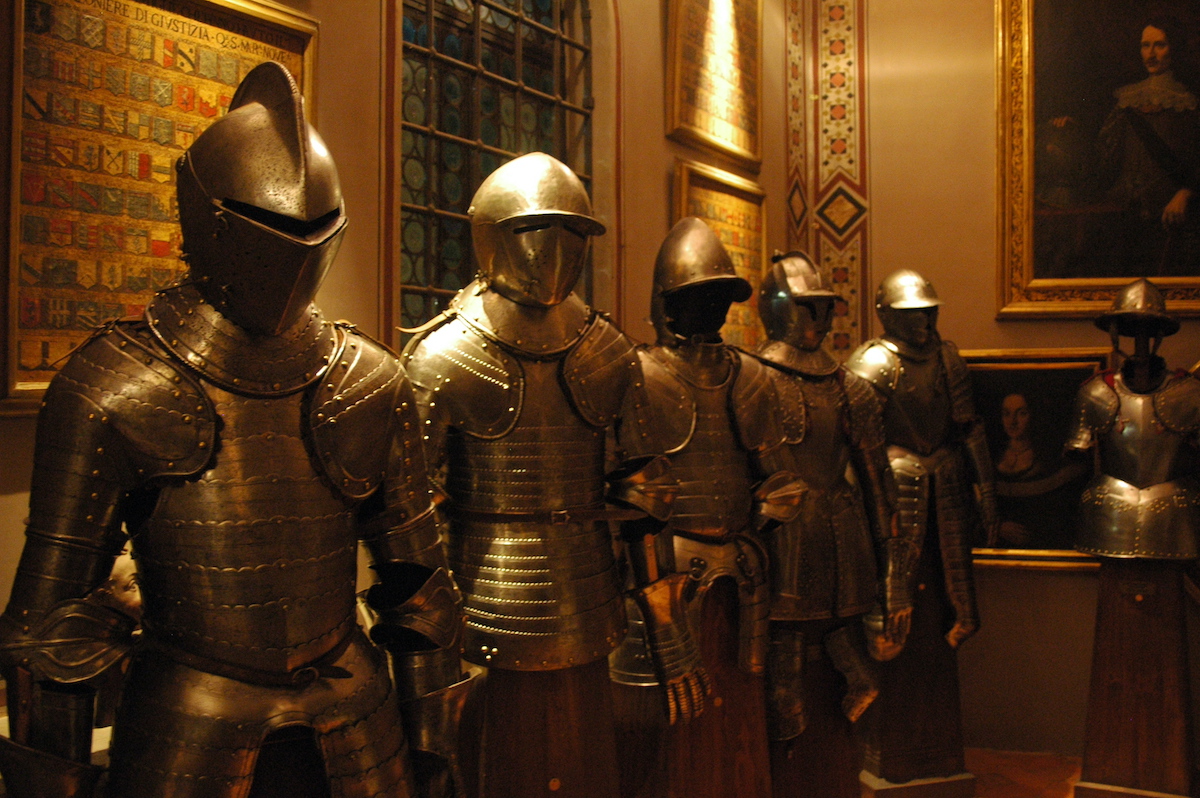 Six suits of armor displayed in a museum