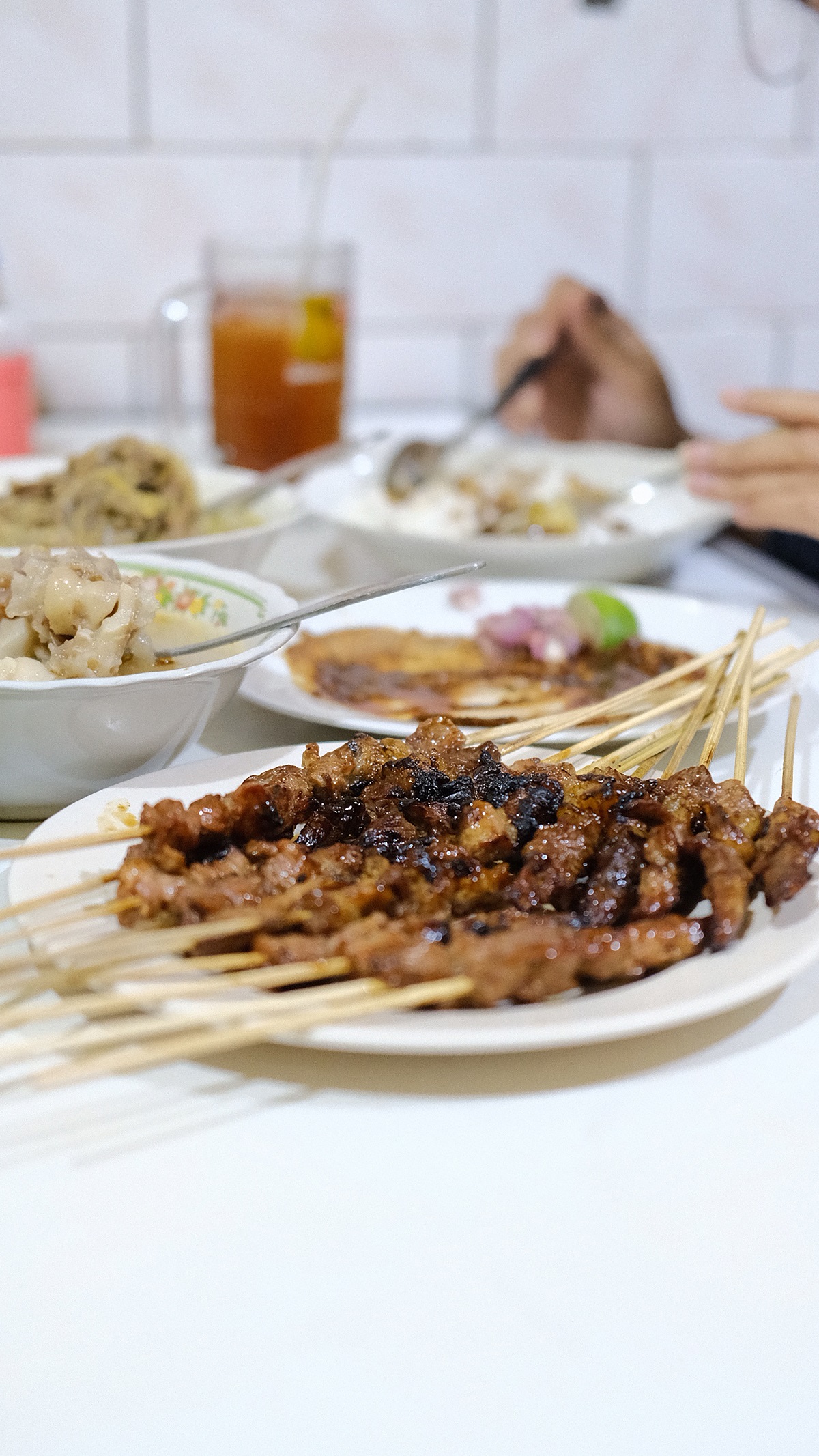 Dishes at an Indonesian restaurants, including satay skewers