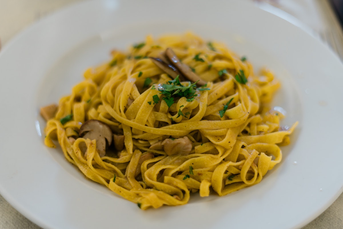 Tagliatelle pasta served with mushrooms and fresh herbs