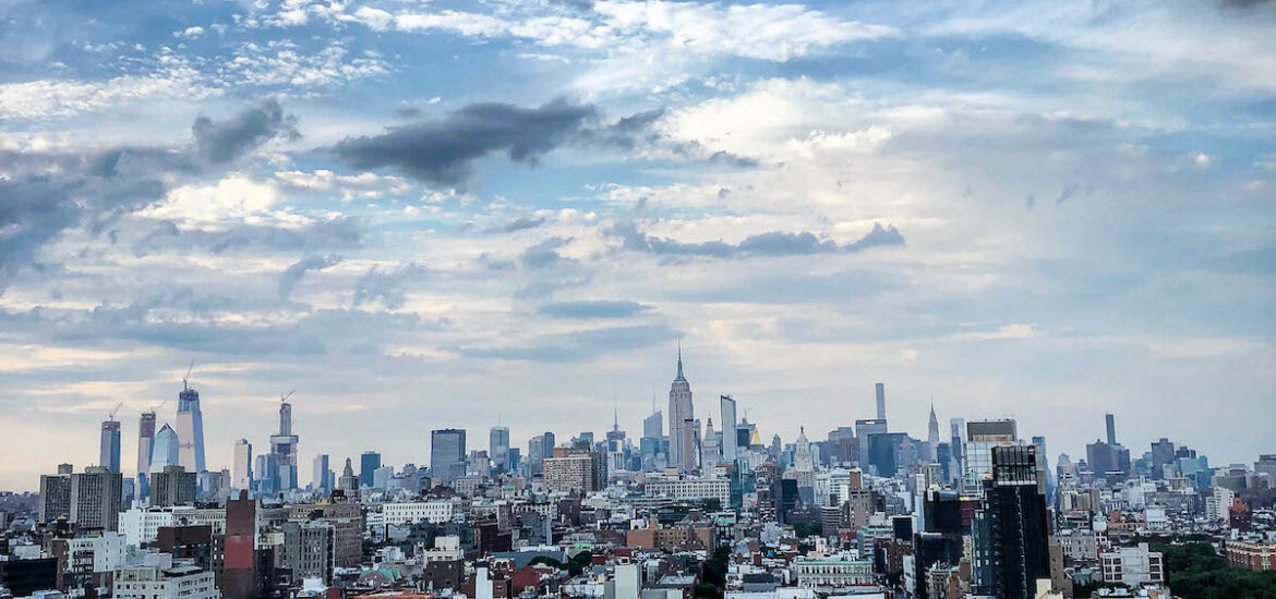 Views over NYC from a rooftop bar on a partly cloudy day