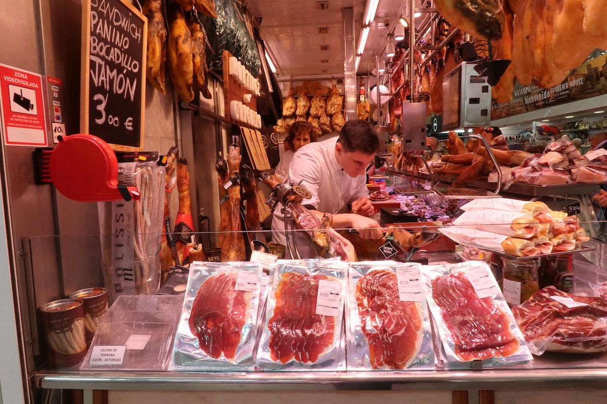 man cutting ham in a stand