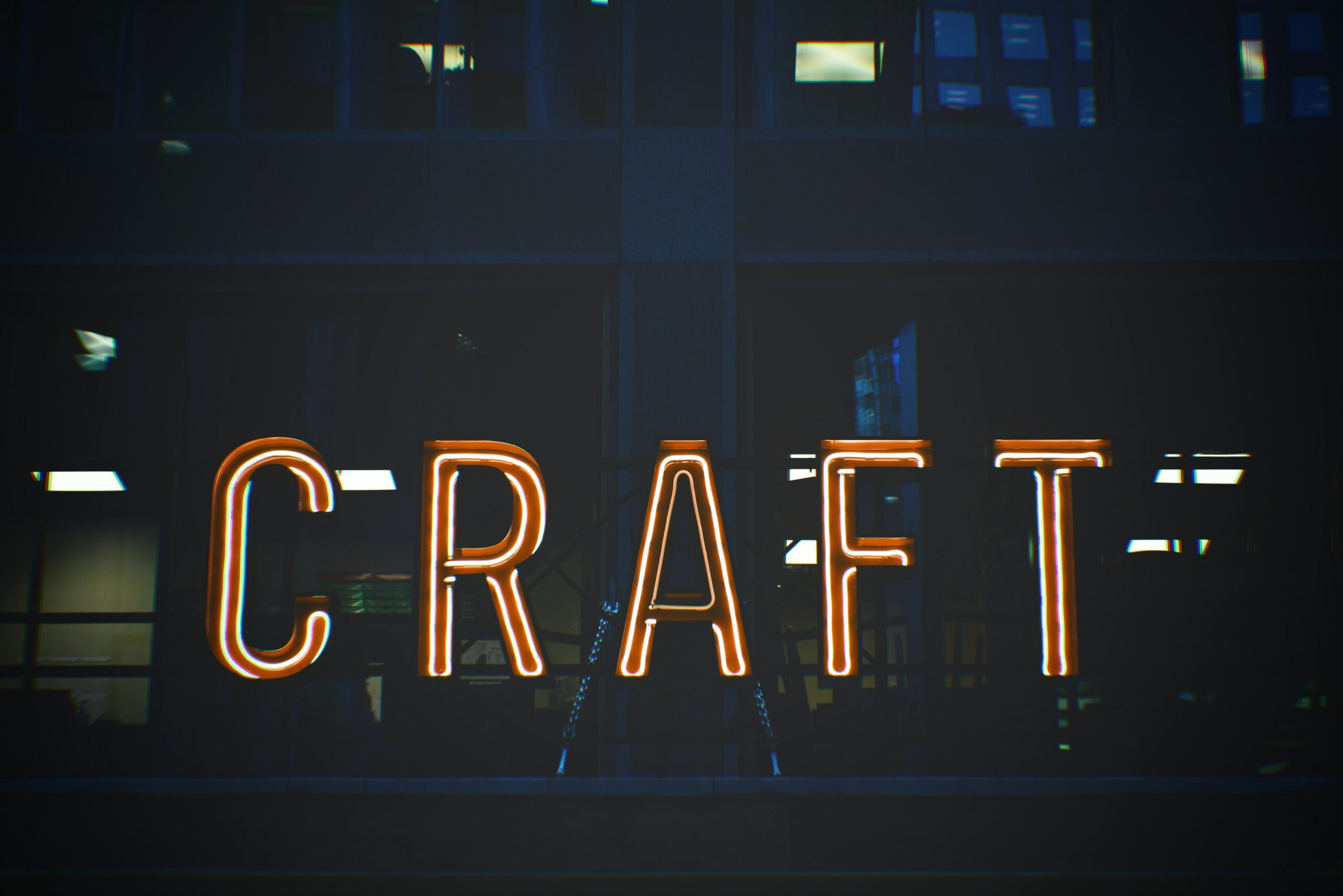 A neon light sign displaying the word CRAFT