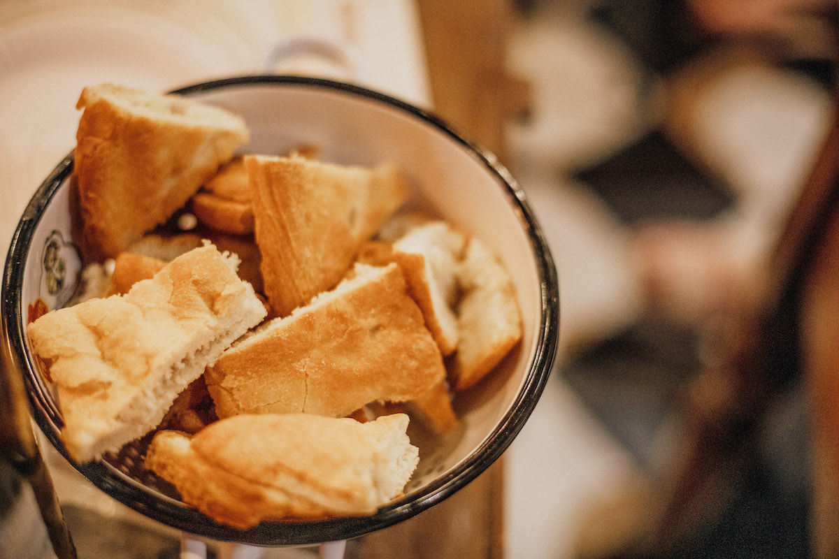 Tuscan bread sliced into thick chunks and served in a ceramic bowl