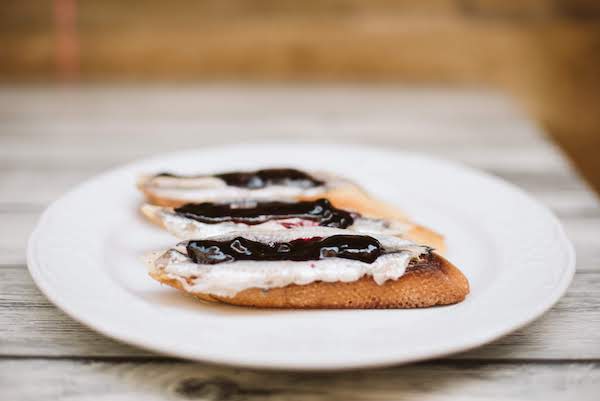 Anchovies on bread with blueberry jam